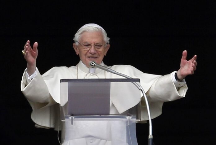 Pope Benedict XVI gestures as he leads his last Sunday Angelus prayer before stepping down in Saint Peter's Square at the Vatican