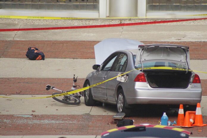 A car which police say was used by an attacker to plow into a group of students is seen outside Watts Hall on Ohio State University's campus in Columbus
