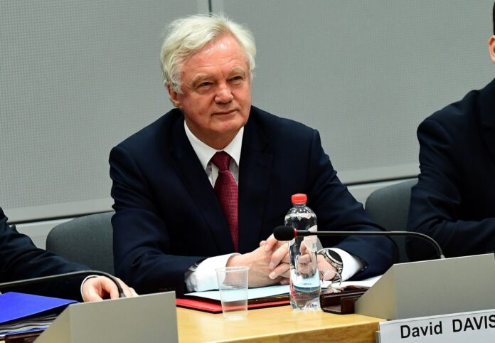 Britain's Secretary of State for Exiting the European Union David Davis and his delegation sits across from European Commission member in charge of Brexit negotiations at the start of their first day of talks at the European Commission in Brussels