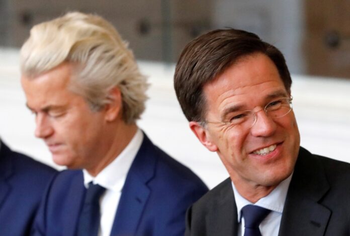 FILE PHOTO: Dutch Prime Minister Rutte talk with Dutch far-right politician Geert Wilders of the PVV Party during a meeting at the Dutch Parliament in The Hague