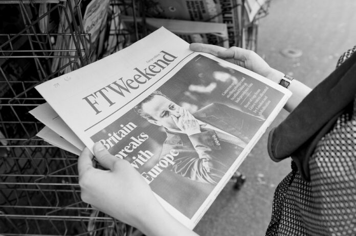 Woman Buying Ft Weekend Newspaper With Shocking Headline About B