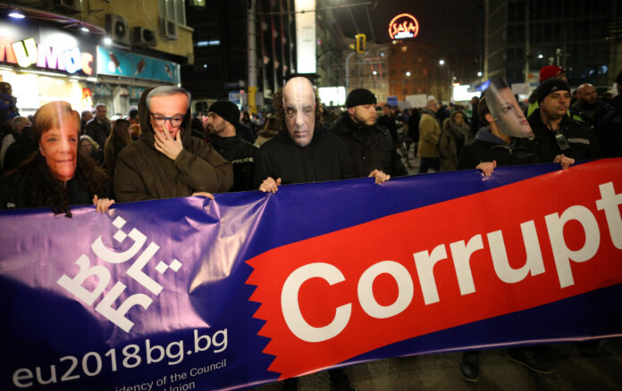 Anti-corruption protesters wear masks depicting German Chancellor Merkel, EU Commission President Juncker, Bulgaria's Prime Minister Borissov and Minister for the Bulgarian Presidency of the Council of the EU Pavlova, during a demonstration in Sofia