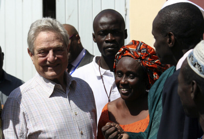 Billionaire financier and philanthropist Soros meets the organizers of a training centre in Dakar