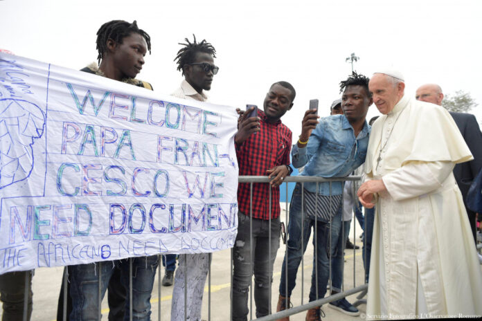 Pope Francis makes a selfie as he visits a migrant's reception centre during a pastoral visit in Bologna