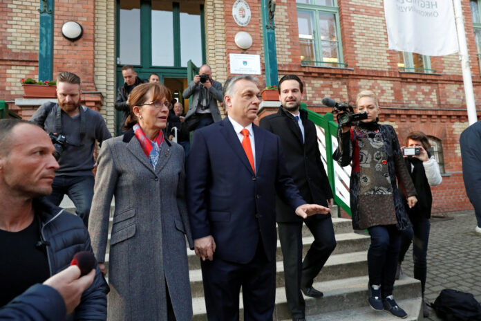 Current Hungarian Prime Minister Viktor Orban and his wife Aniko Levai leave a polling station during Hungarian parliamentary election in Budapest