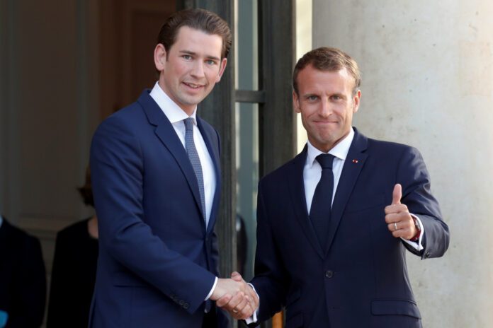 French President Emmanuel Macron greets Austrian Chancellor Sebastian Kurz as he arrives for a meeting at the Elysee Palace in Paris