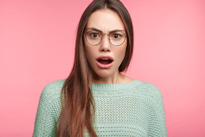Stupefied Shocked Woman Looks With Shocked Expression Into Camer