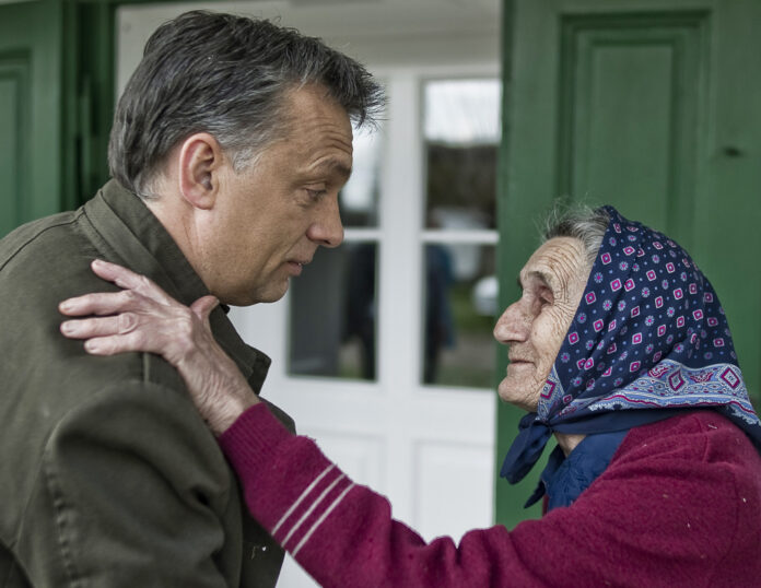 Hungarian opposition Fidesz party leader Viktor Orban greets a supporter at a ranch near the village of Fulophaza