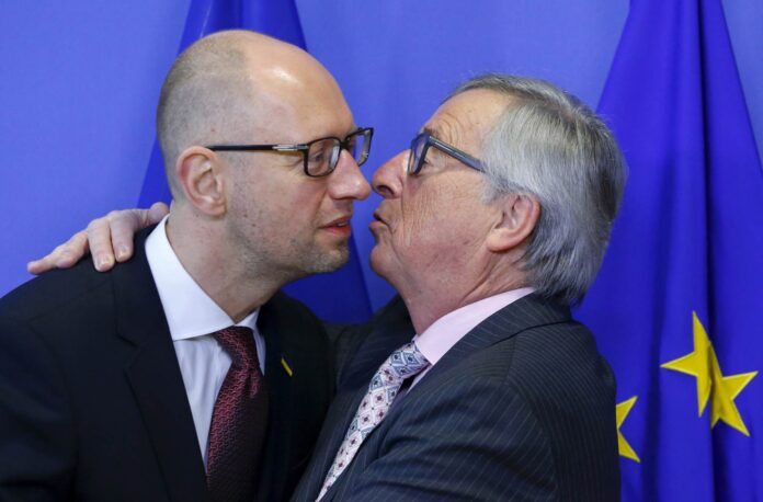 Ukrainian Prime Minister Yatseniuk is welcomed by European Commission President Juncker at the EU Commission headquarters in Brussels