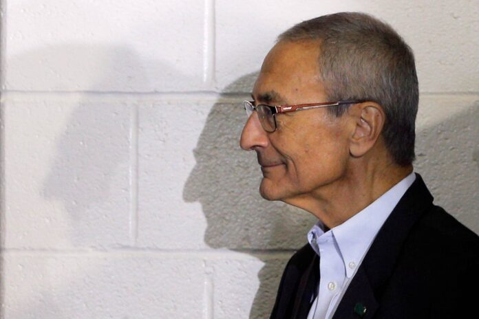 Campaign chairman John Podesta watches from the edge of the stage during a campaign rally with U.S. Democratic presidential nominee Hillary Clinto at Heinz Field in Pittsburgh