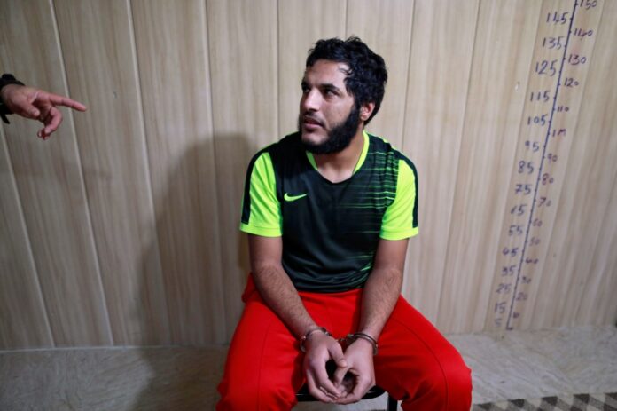 An Islamic State member listens to a counter-terrorism agent in Sulaimaniya