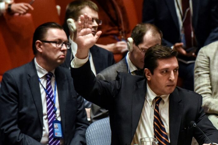 Russian Deputy Ambassador to the United Nations Vladimir Safronkov votes against a draft resolution condemning the reported use of chemical weapons in Syria at the Security Council meeting on the situation in Syria in New York