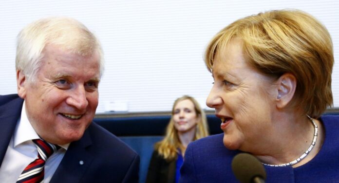 German Chancellor Merkel, leader of the Christian Democratic Union Party (CDU) and Seehofer, head of the CSU attend their first parliamentary meeting after general election in Berlin