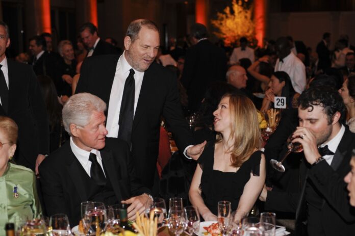 Harvey Weinstein, second from left, greets Chelsea Clinton and former President Bill Clinton at the amfAR gala at Cipriani Wall Street in New York.