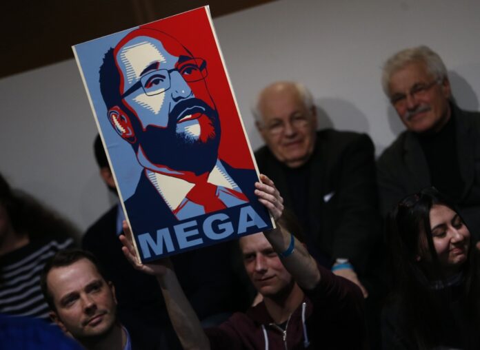 People hold poster showing former EU parliament president Schulz during SPD meeting in Berlin