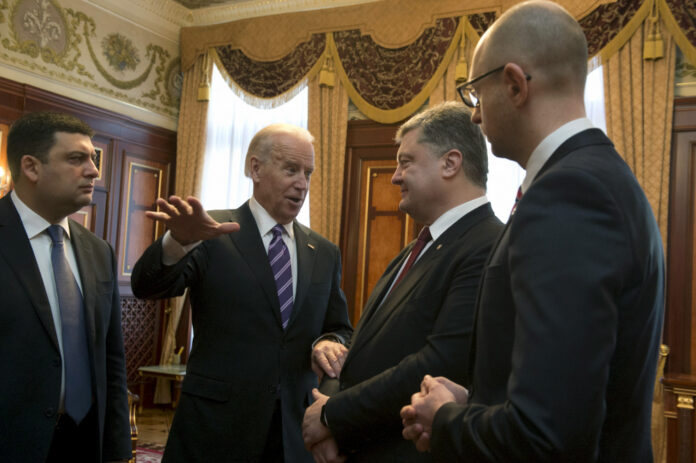 US Vice President Biden gestures as he talks with Ukraine's President Poroshenko, Prime Minister Yatseniuk and the parliament Speaker Groysman at the parliament in Kiev