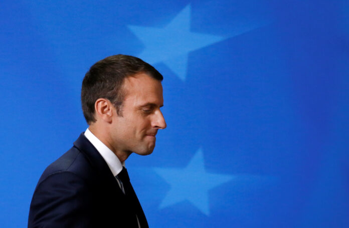 French President Emmanuel Macron arrives at a press conference at the EU summit in Brussels