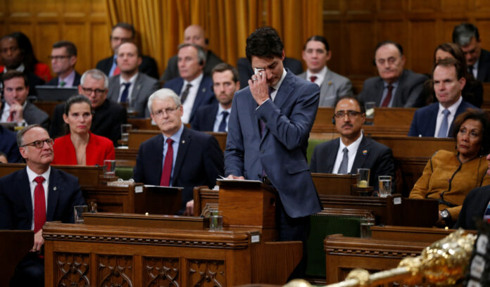 Canada's PM Trudeau wipes away tears while delivering an apology to members of the LGBT community on Parliament Hill in Ottawa
