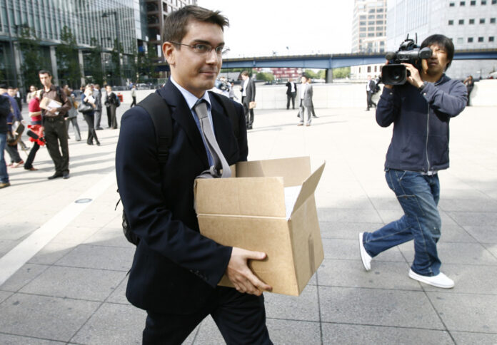 A worker carries a box away from the office of the U.S. investment bank, Lehman Brothers, in London