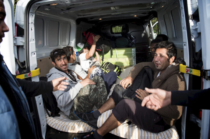 File photo shows migrants leaving Rodby in a private car driving towards Sweden