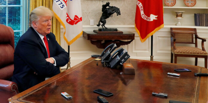 U.S. President Trump answers question as eight devices record him during interview with Reuters in Oval Office of White House in Washington