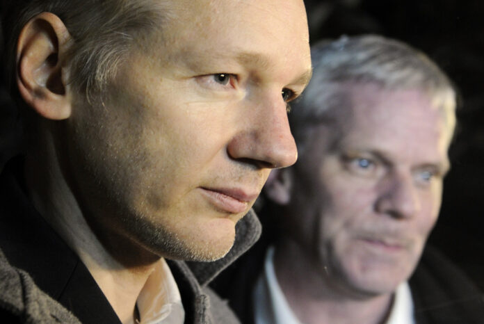 WikiLeaks founder Assange speaks to the media outside Ellingham Hall as WikiLeaks spokesperson Hrafnsson looks on in Norfolk