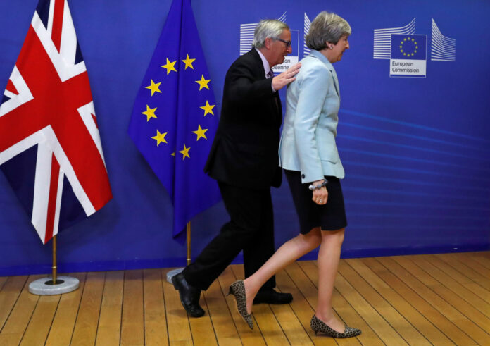 Britain's Prime Minister Theresa May is welcomed by European Commission President Jean-Claude Juncker at the EC headquarters in Brussels