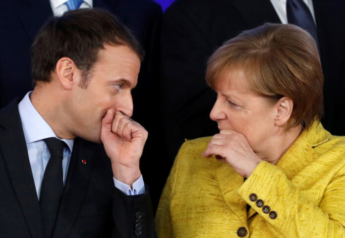 French President Emmanuel Macron and German Chancellor Angela Merkel take part in a group photo on the launching of PESCO