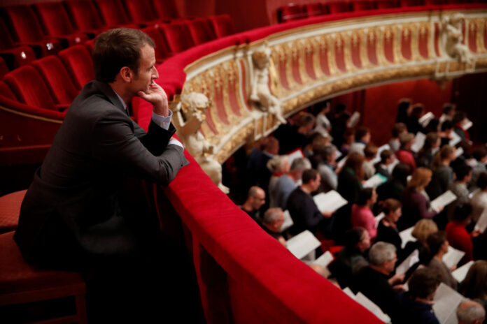 French President Emmanuel Macron follows a rehearsal of a non-professional chorus at Strasbourg's Opera