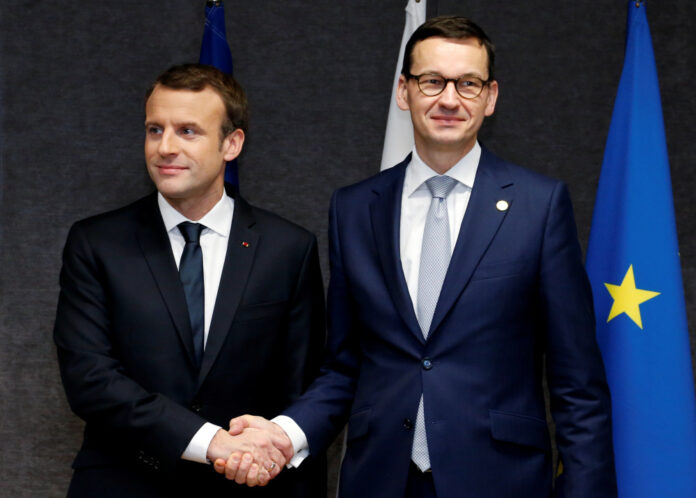 French President Macron and Poland's PM Morawiecki pose ahead of a bilateral meeting at a EU leaders summit in Brussels
