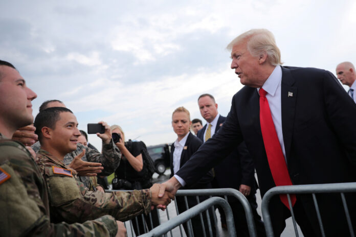 U.S. President Donald Trump greets members of the military as he arrives at Raleigh County Memorial Airport in Beaver, West Virginia, U.S.